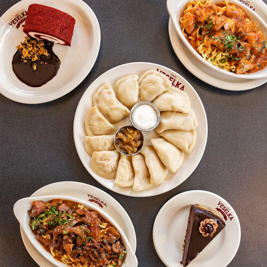 Pierogi, pyana vsyhna, chicken paprikash, beef stroganoff, and red velvet roulade all on plates. Finals Care package