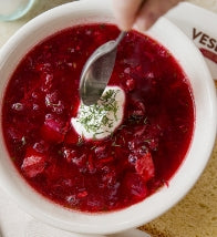 Spoon going into a bowl of borscht