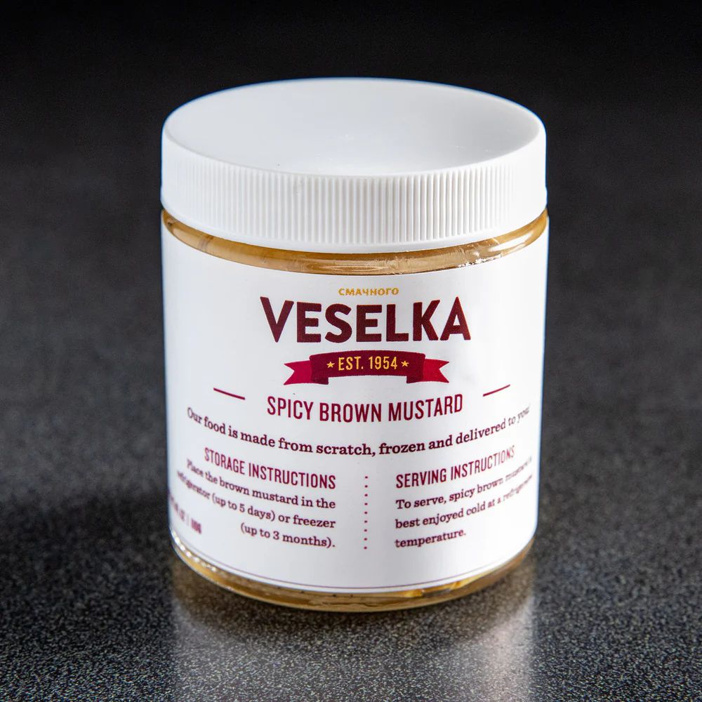 Spicy Brown mustard in a plastic jar with a label on the front