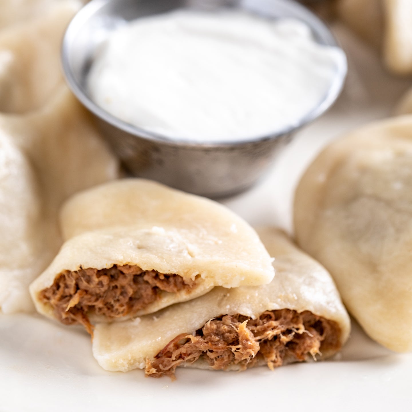 Braised beef pierogi cut open, boiled on a plate 