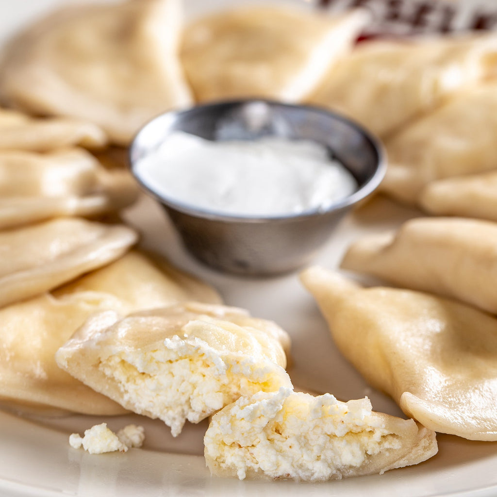 Cheese pierogi cut open, boiled on a plate 