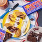 Multiple Chocolate Brownie pierogi cut open and oozing, pierogi are fried with tony's chocolate bars open and in full packaging scattered around 
